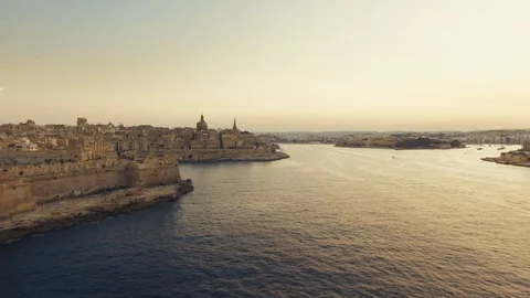 Drone flying backwards in Valletta at Sunset Stock Footage 90779158