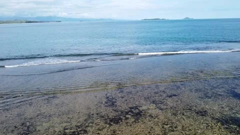 Drone Flying From Beach Toward Blue Ocean Video stock 197979292