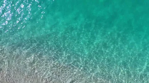 Drone Flying from Beach Waves to Turquoise Sea Surface Stock Footage 330883291