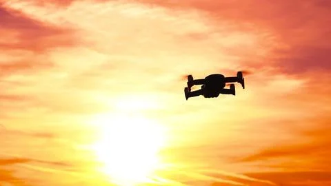 Drone Flying on Beautiful Sunset background. Aircraft hovers on air. Soft focus Stock Photos