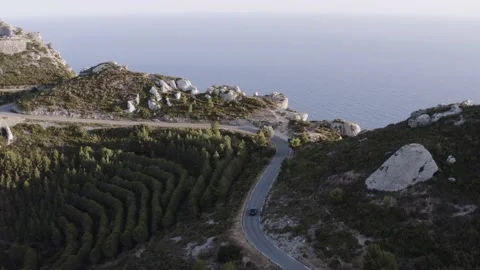Drone flying behind car at mountain road  Stock Footage 202018067