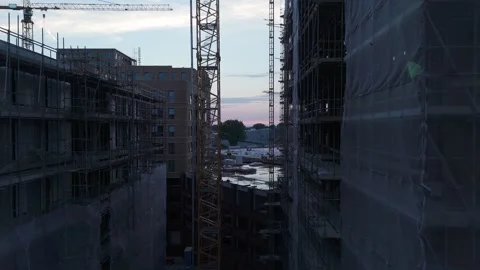 Drone flying between new construction buildings at dusk Stock Footage 345255558