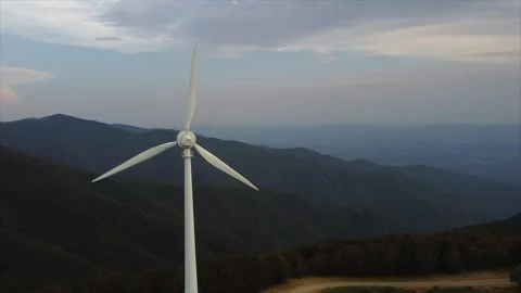 Drone flying between tall turbines in cloudy light Stock Footage 322798664