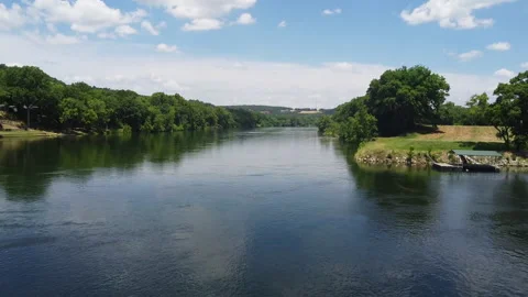 Drone flying a bit low over a river in a Norfork park. Stockbeeldmateriaal 200981830