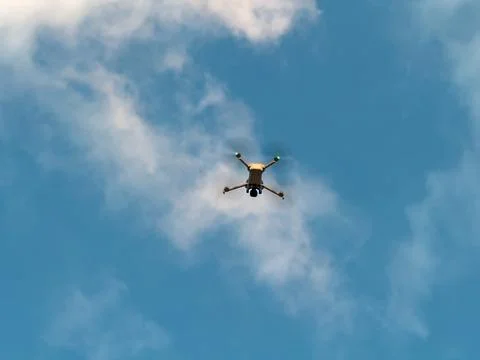 Drone flying in blue sky with clouds for technology concept Stock Photos