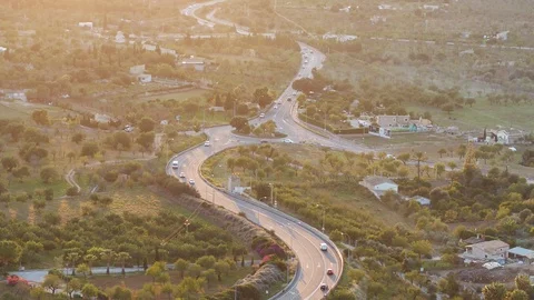 Drone flying by busy round about at sunset Stock Footage 100292317