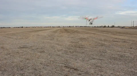 DRONE FLYING AT CAMERA QUAD-COPTER REMOTE RADIO CONTROLLED FLYING MACHINE Video stock 34514148