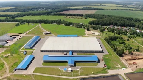 Drone flying in circular path over farm facility Video stock 333278331