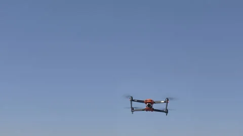 Drone flying in clear blue sky, capturing aerial views from above Vídeos de archivo 344747538
