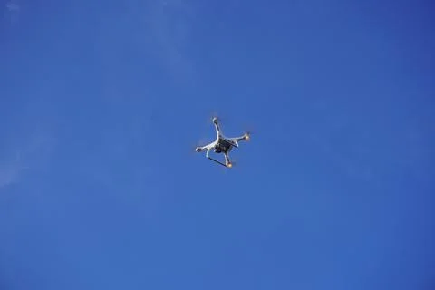 Drone flying in clear blue sky 스톡 사진