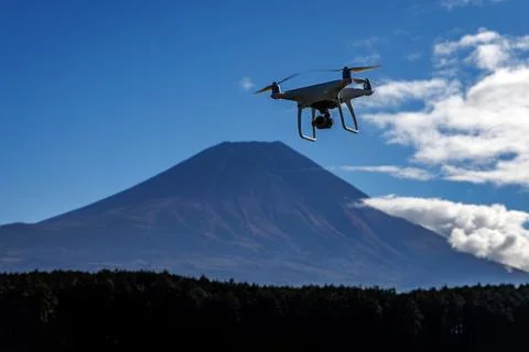Drone Flying in Clear Blue Sky with Mount Fuji Background Stock Photos