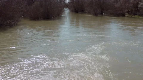 Drone flying close above  dirty river. Aerial 4K shot Stockbeeldmateriaal 151551915