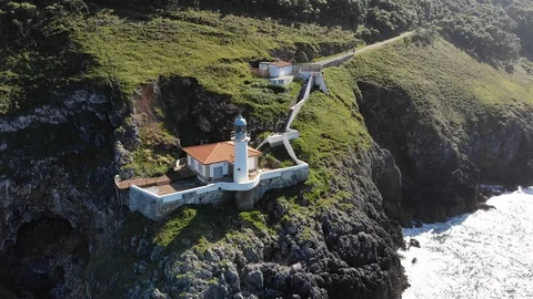 Drone flying close to cliff with lighthouse Stock Footage 114748156