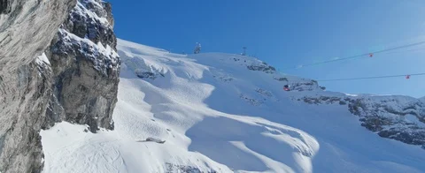 Drone flying close to mountain flying towards ski lift which going up. Aerial  Stock Footage 121476887