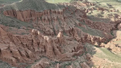 Drone flying close to red sandstone hoodoos, Kok-Moinok Canyons, Kyrgyzstan Видео 347239548