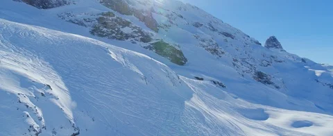 Drone flying close to the snow covered mountain surface. Ski tracks. Aerial view Stock Footage 121479241