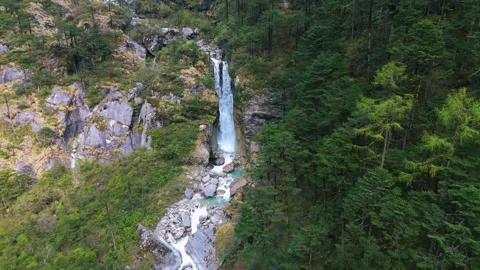 Drone flying close to the thunderous waterfall surrounded by lush greenery. Stock Footage 311389124