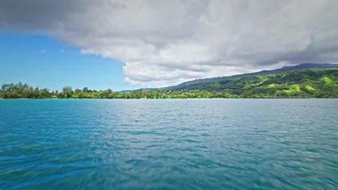 Drone flying close to water approaching tropical island. Video stock 167429808