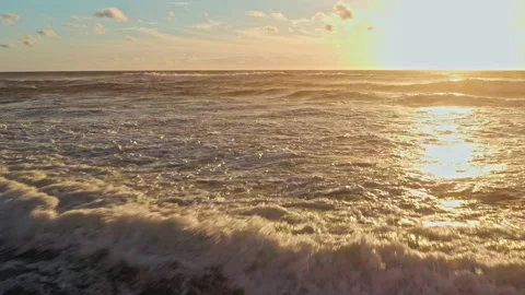 Drone is flying closely to water surface of the ocean during sunset. Aerial.. Stock Footage 239580254