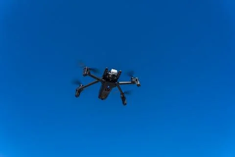 Drone flying in from of a clouds sky Stock Photos
