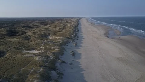 Drone flying directly above border between North sea beach and dunes Stock Footage 87255943