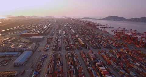 Drone flying directly over containers on Port of Shanghai into the sunset 스톡 동영상 93535719