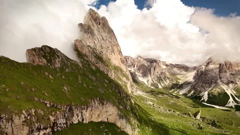 Drone Flying Into Dolomite Valley with Seceda Mountain and Clouds on Left Stock Footage 313892080