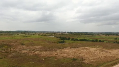 Drone flying down, landing on green grass landscape Stock Footage 73717350