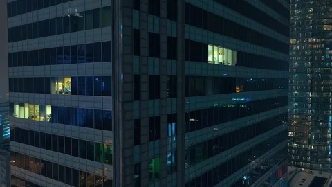 The drone is flying down a modern, glazed skyscraper. Stock Footage 108569910