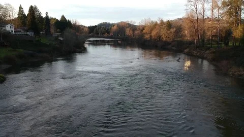 Drone Flying Down River at Dusk Stock Footage 84081876