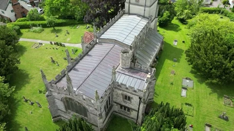 Drone flying down side of St Mary's Church North Marston Stock Footage 242600437