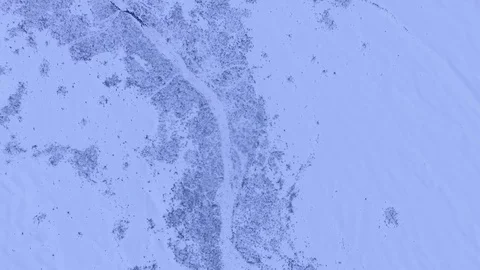 Drone flying down view of snow patterns on the ground. Stock Footage 82902781
