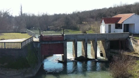 Drone flying downstream over an abandoned dam on the river Stockbeeldmateriaal 125292450