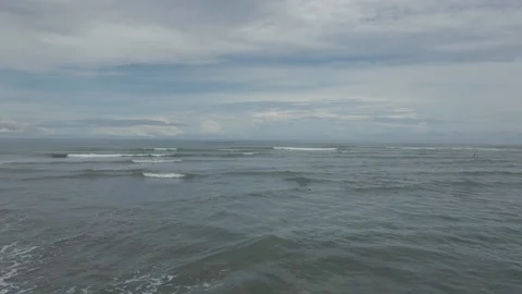 Drone Flying Fast and Low Over The Ocean Shoreline Low Tide Stock Footage 213885199