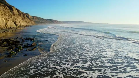 Drone Flying Fast Over the Coastline - Waves Mountains and Blue Sky Stock Footage 132531793