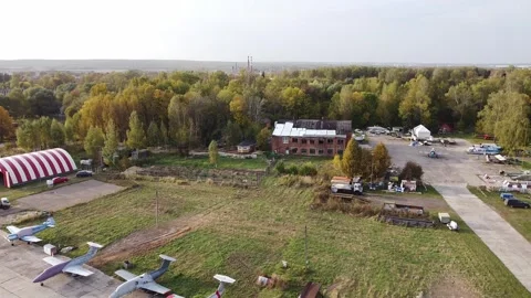 Drone flying forward above airfield and buildings Video stock 333625267