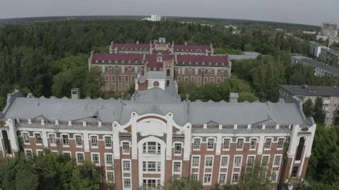 Drone flying forward above forest and buildings Stock Footage 333011962