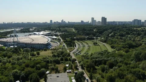 Drone flying forward above stadium and green landscape Stock Footage 322528668