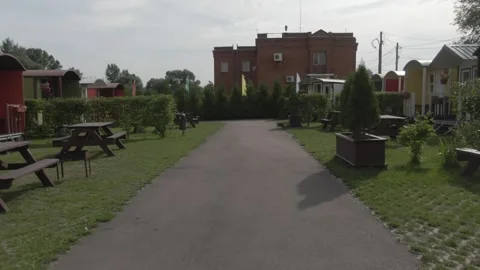 Drone flying forward along camping park pathway Stock Footage 333954606