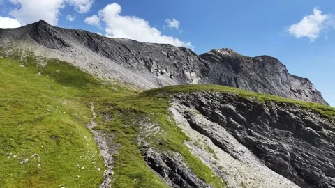Drone flying forward along rocky ridge above Segnesboden Plateau in Swiss Alps Stock Footage 320111442