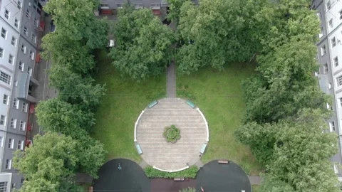 Drone flying forward and tilting up in courtyard Stock Footage 332684073