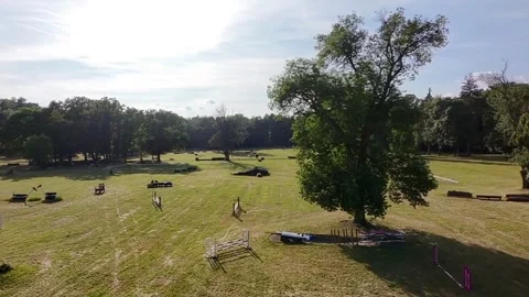 Drone Flying Forward and Upward in a Park Preparing for Horse Races Stock-Footage 313819609