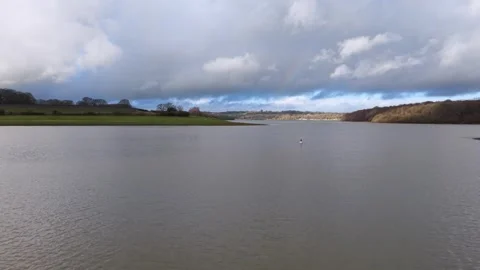 Drone flying forward low over lake and shoreline Stock Footage 326975438