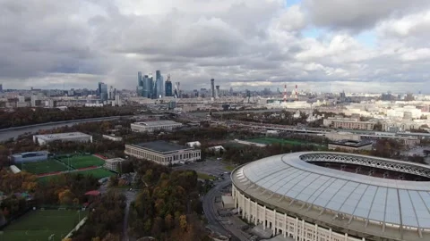 Drone flying forward over city stadium and skyline Stock Footage 323875516