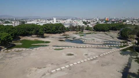 Drone flying forward over El Dean Park in Guadalajara showing dry lake Stock Footage 321308522