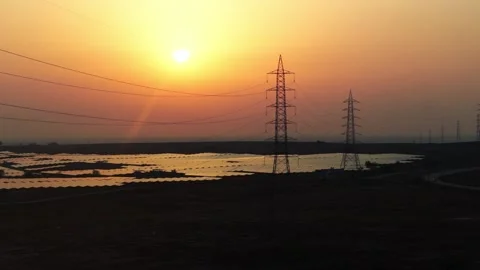 Drone Flying Forward Over Massive Solar Farm at Golden Sunset with High Volt Stock Footage 338066352