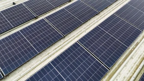 Drone Flying Forward Over Neat Solar Panels On Corrugated Metal Roof Video stock 330750409