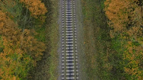 Drone flying forward over railway track while beautiful sunset. Suburban railway Stock Footage 230997701
