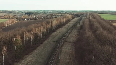 Drone flying forward over railway track while beautiful sunset. Suburban railway Stock-Footage 241013082