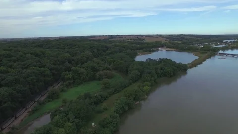 Drone Flying Forward Over River Toward Train Stock Footage 78888481